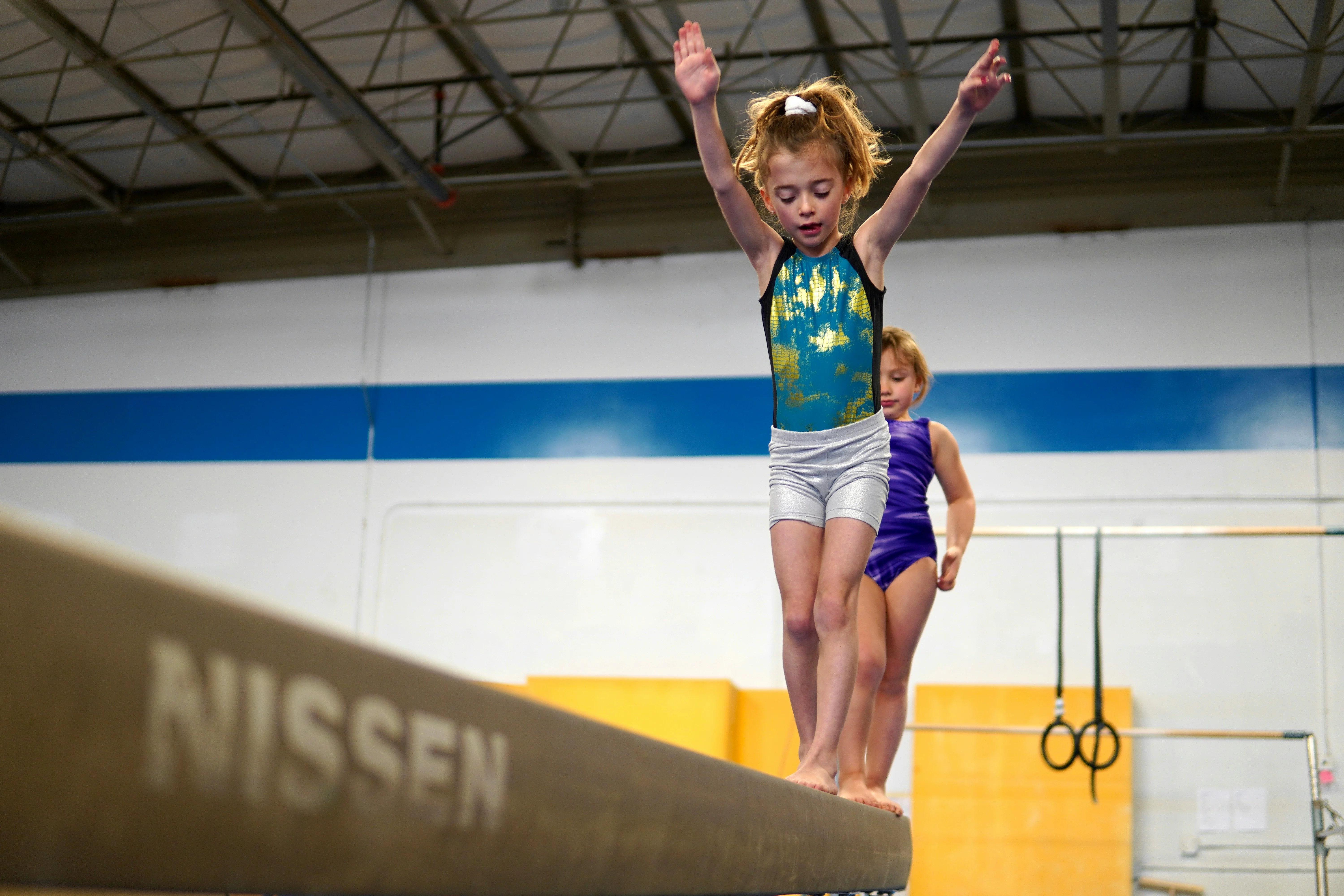Young gymnast on balance beam